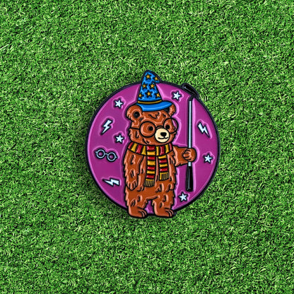 golf ball marker of bear wearing wizard hat and holding putter
