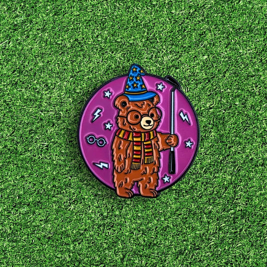 golf ball marker of bear wearing wizard hat and holding putter like harry potter