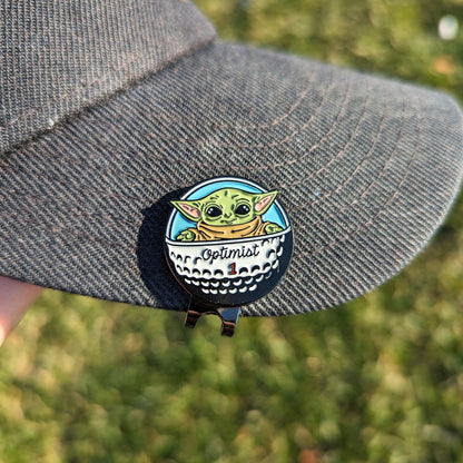 golf ball marker of green star baby in golf ball spaceship clipped on hat